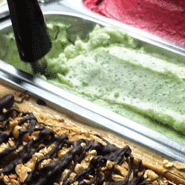 The image shows a close up of our gelato being scooped from the freezer of our beautiful gelato trike. Sussex wedding caterer