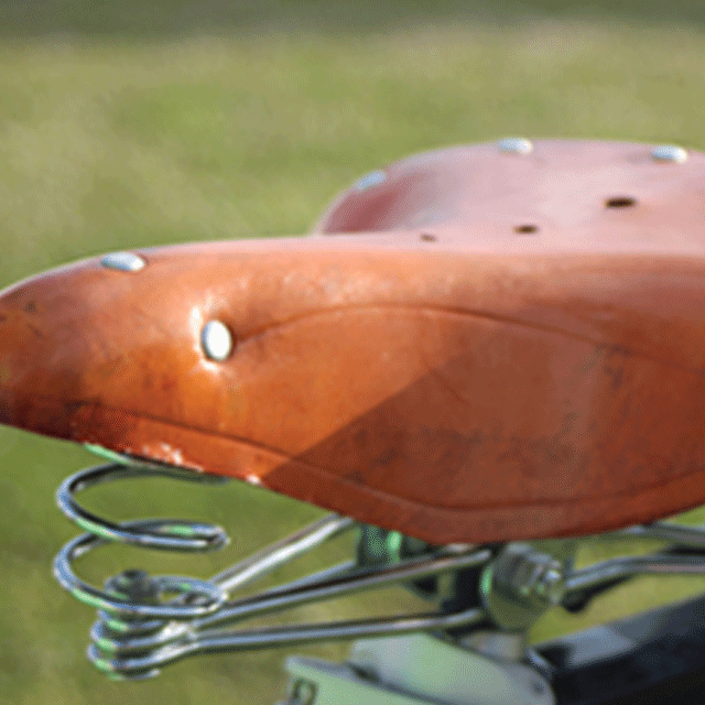 Another close up detail from our well sprung gelato trike, a traditional tan leather tricycle seat with chrome springs. Summer wedding caterer Sussex